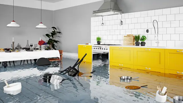Flooded modern kitchen with water spreading across the floor