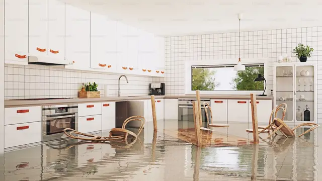 Kitchen with floodwater covering the floor and chairs